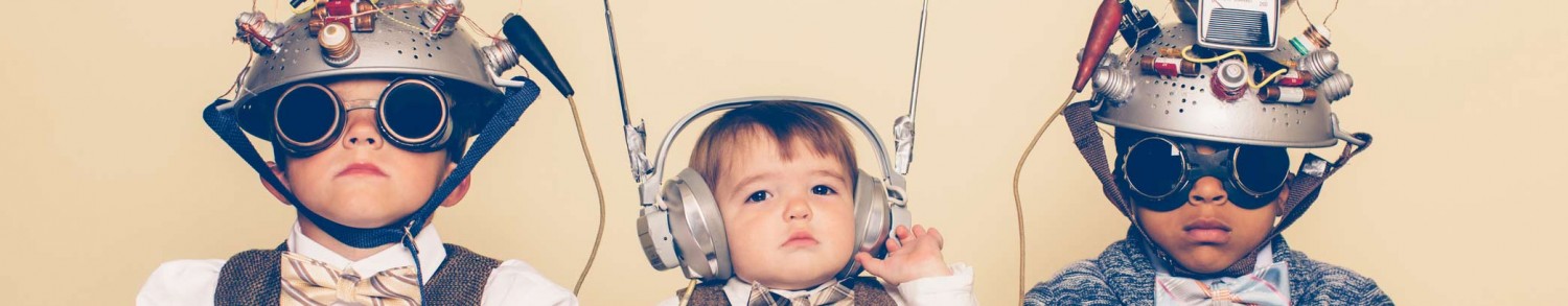 3 Children wearing makeshift space helmets made of pasta strainers and wires and wearing goggles